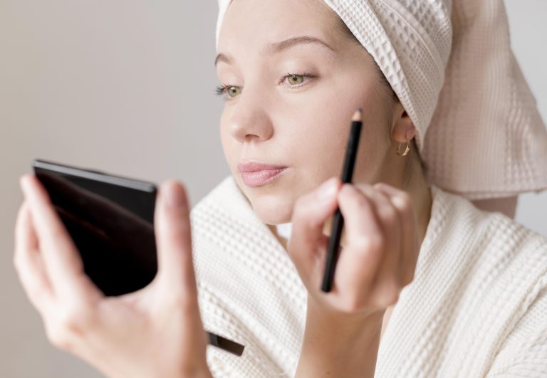 young-female-applying-eyeliner